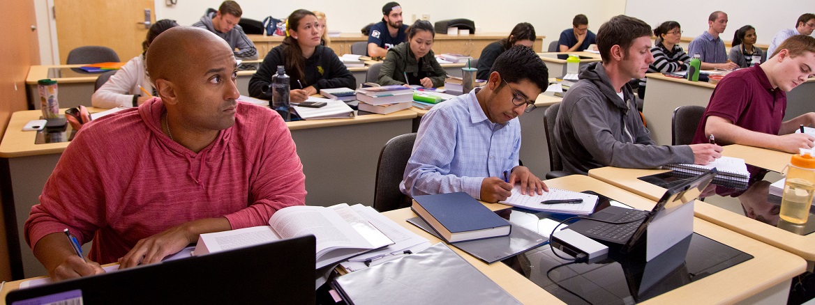 Students work at table desks during a business class in the Morken Center for Learning & Technology