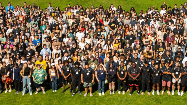 The class of 2028 stands together in a group and looks at the camera.