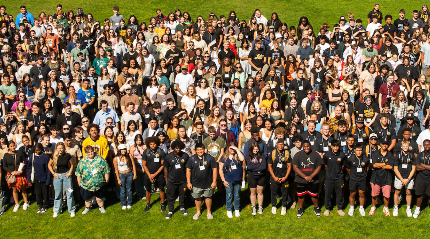 The class of 2028 stands together in a group and looks at the camera.