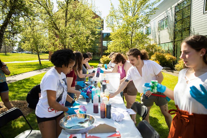 PLU students tie-dying lab coats