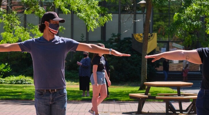 Students wearing masks and staying 6 feet apart.