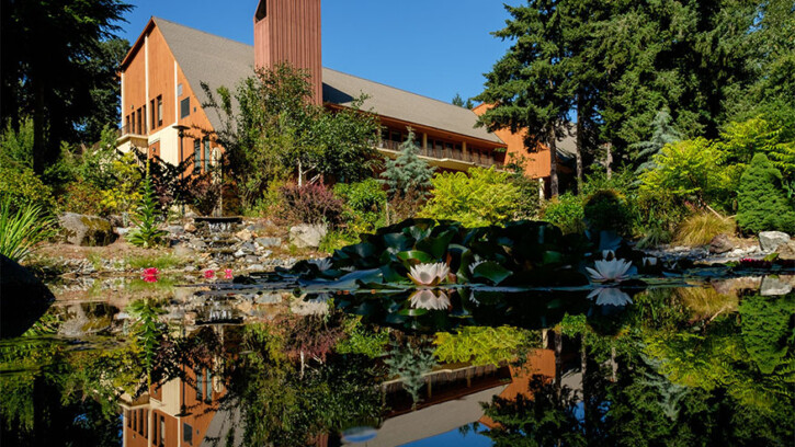 The Anderson University Center reflected in a pond.