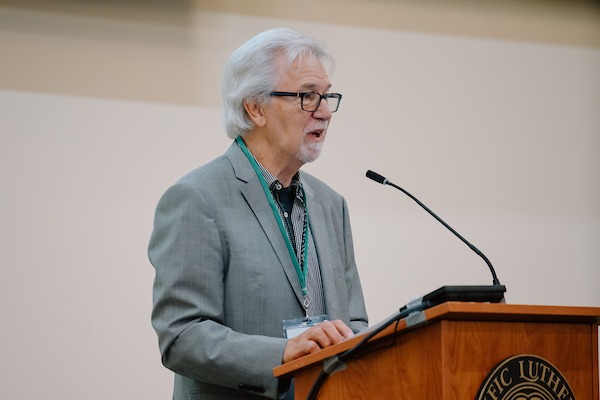 Convener and faculty emeritus Robert Erickson introduces Dr. Edward Kissi, Associate Professor in the Department of Africana Studies at the University of South Florida, before his keynote address titled “Sub-Saharan Africans and the Holocaust” during the 15th Annual Powell-Heller Conference for Holocaust Education, Wednesday, Oct. 25, 2023, at PLU. (PLU Photo / Emma Stafki).