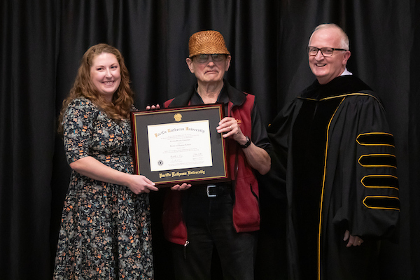 Cecilia Svinth Carpenter’s granddaughter accepts her grandmother’s honorary degree during the Lutheran Studies Conference, Thursday, Sept. 26, 2024, at PLU. (PLU Photo / Sy Bean)