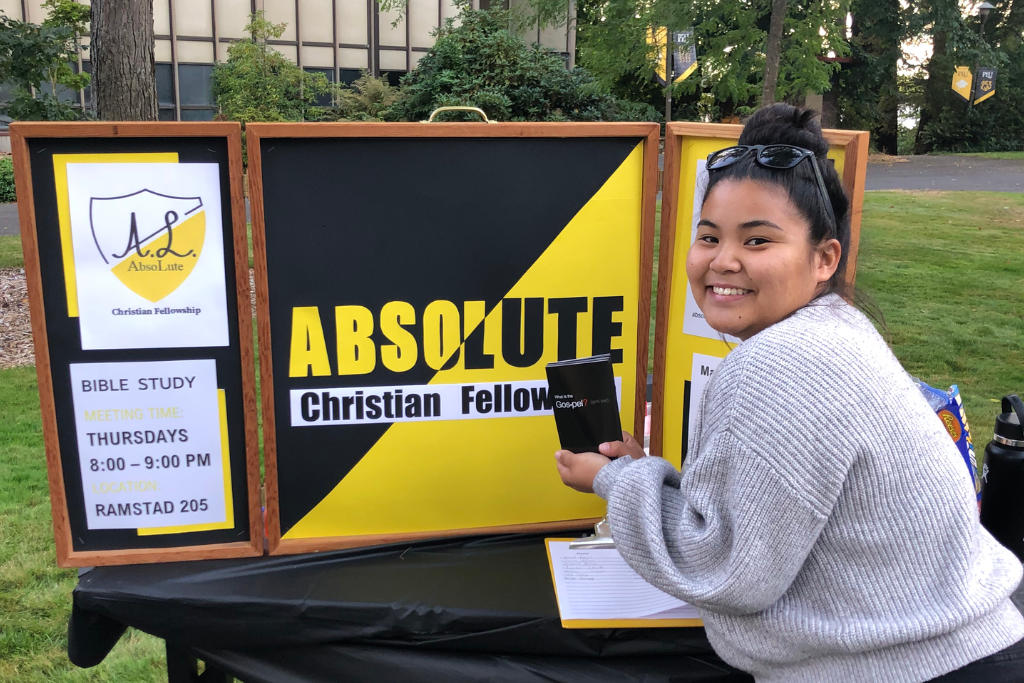 Hayley Maqui next to a bible study sign.