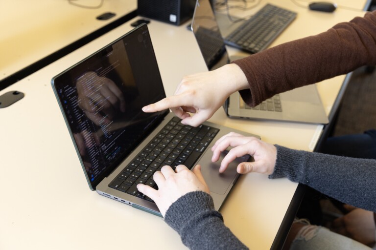 hands typing on a keyboard