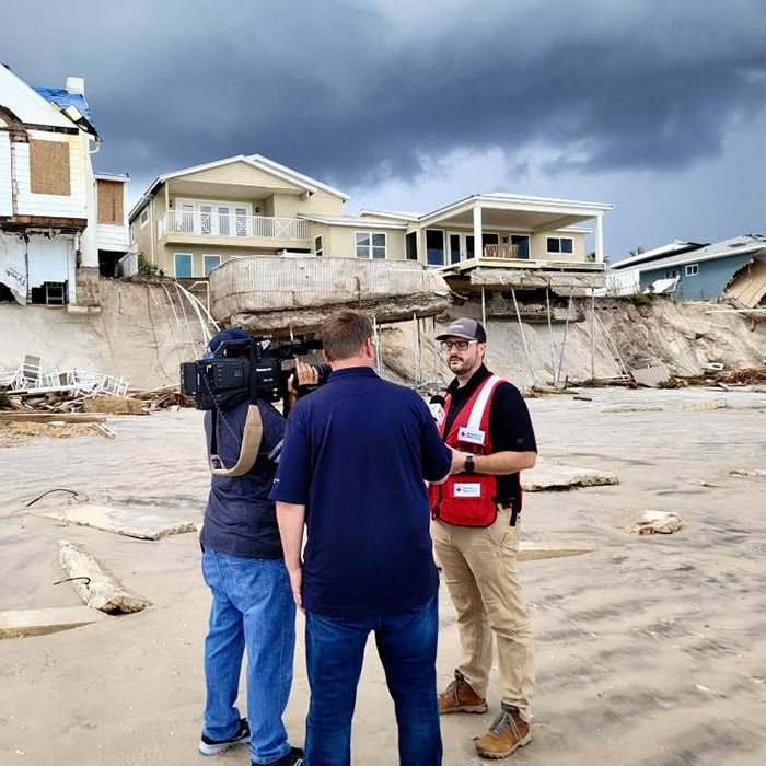 Johnson being interviewed on the beach while helping to coordinate the cleanup work near Daytona Beach.