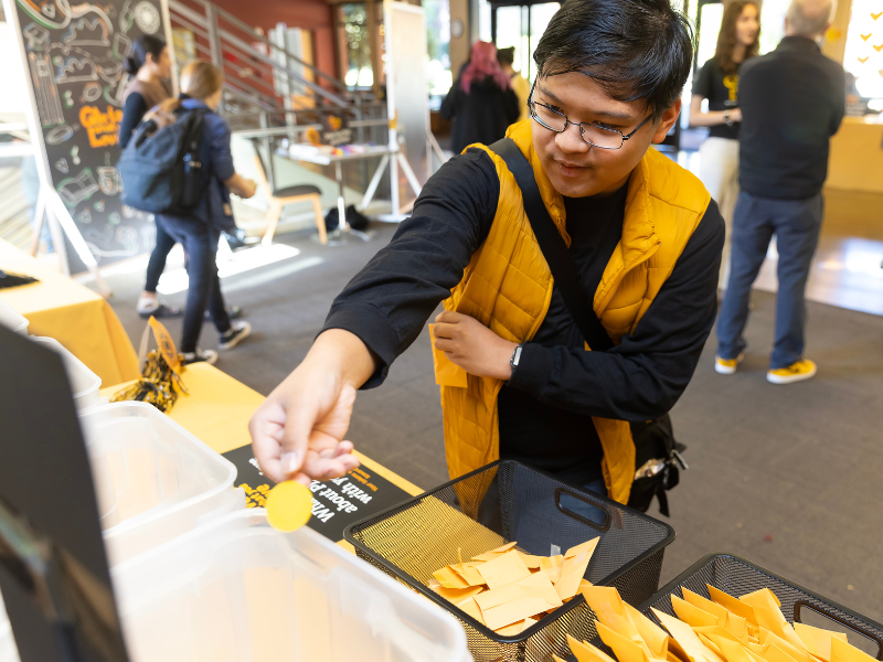 Student places a token in a bucket.